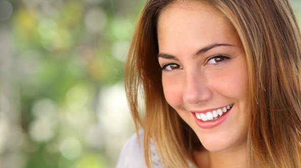 girl smiling at the camera with a toothy grin